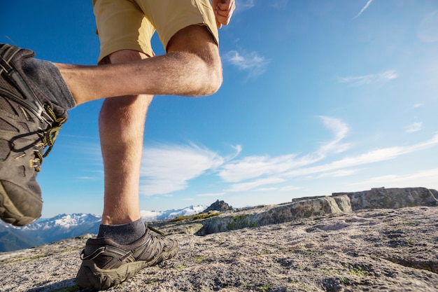 Backpacker in a hike in the summer mountains