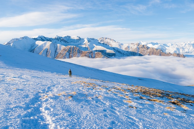 Backpacker hiking on snow on the Alps. 