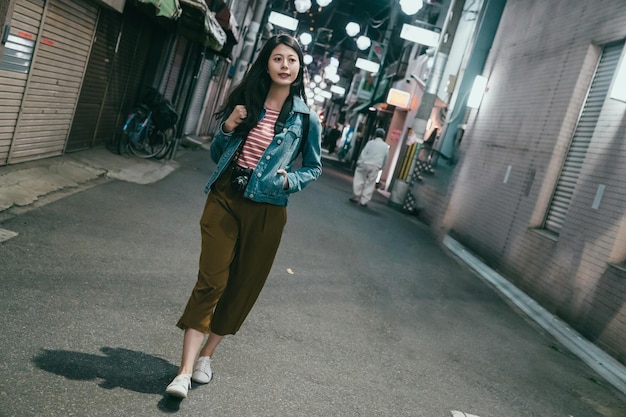 Backpacker standing in urban at night