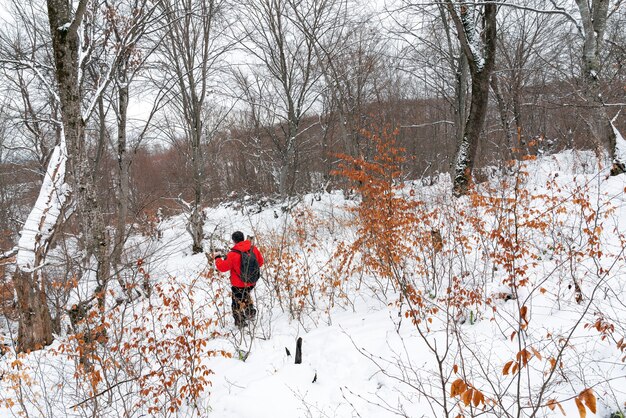 Backpacker traveler in winter mountain forest