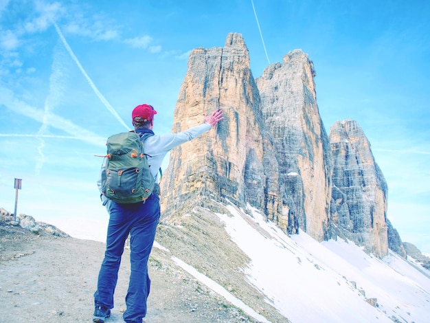 Backpacker on trip aound tre cime di lavaredo in sunny april morning view from tour around popular massive dolomite alps italy