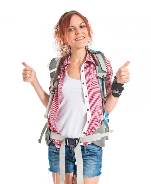 Backpacker with thumb up over white background