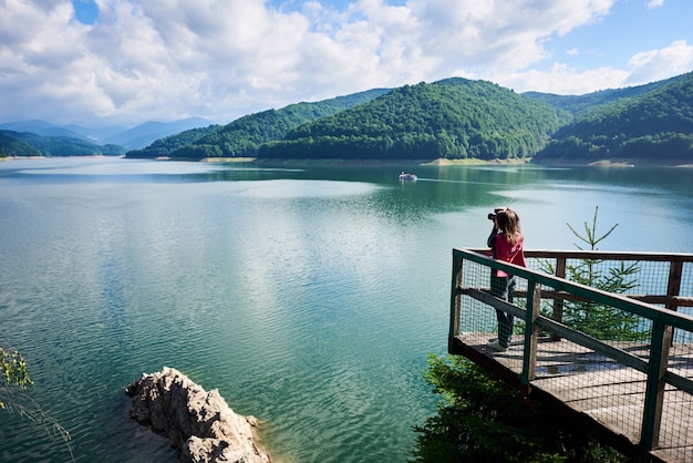 Backpacking at dam Vidraru Lake in Romania