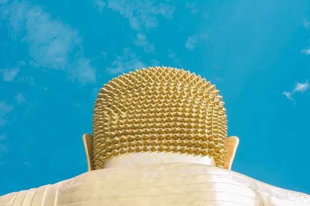 backside of gold buddha statue’s head against sky