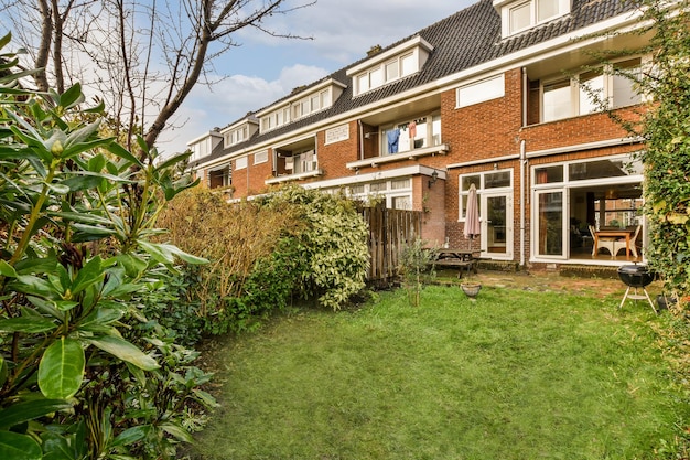 The backyard of a brick house with a green yard