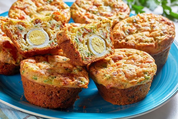 Bacon, Egg and Cheese Breakfast Muffins on  a blue platter on a marble table, horizontal view from above, top view