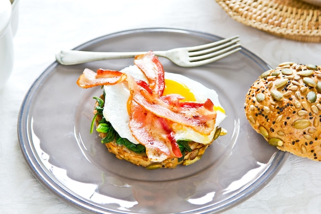 Bacon Fried Egg and Spinach on Sesame Pumpkin seeds Brad