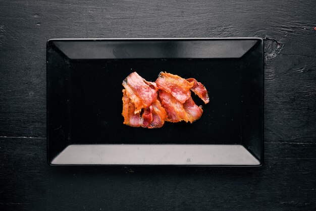 Bacon Roasted On a wooden background Top view Free space for text