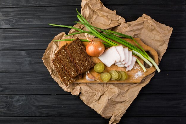 Bacon, rye bread on a wooden board