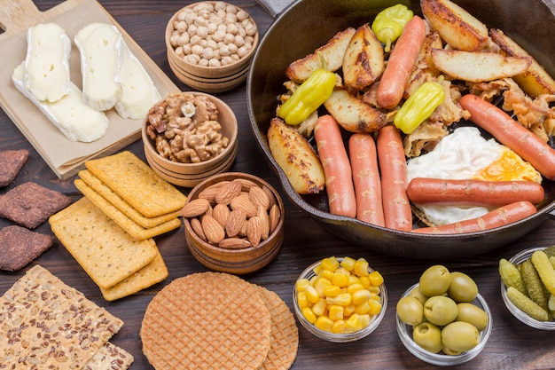 Bacon, sausages, cheese, vegetables, cookies, eggs: ingredients for continental breakfast.