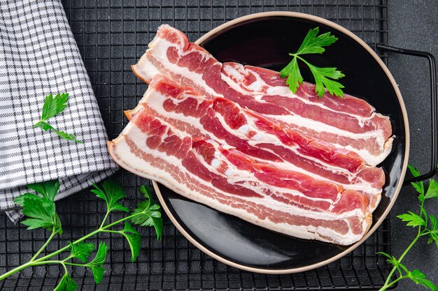 bacon slices fresh meat product pork eating cooking appetizer meal food snack on the table