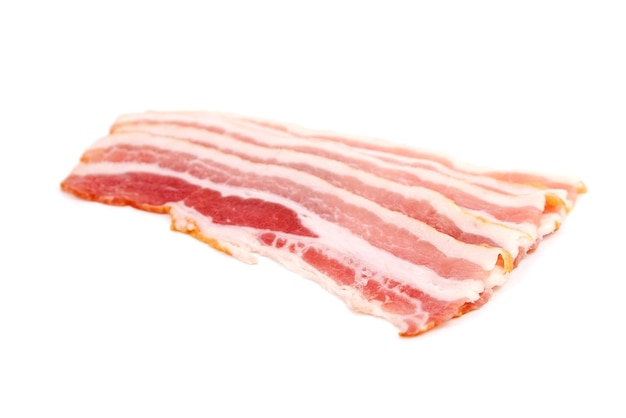 Bacon strips for scrambled eggs raw smoked pork meat slices isolated on white background