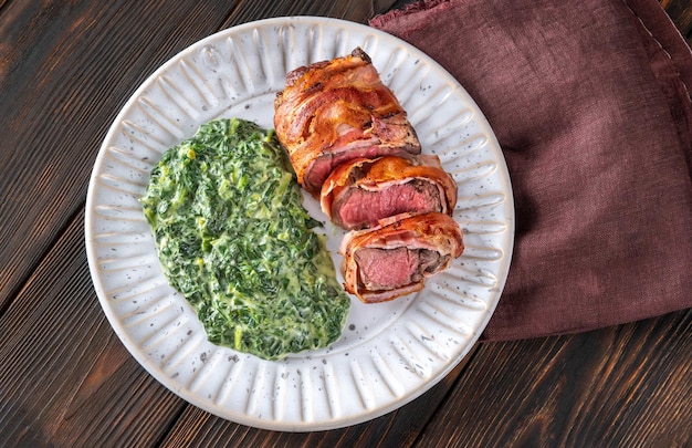 Bacon-wrapped beef steack with creamed spinach