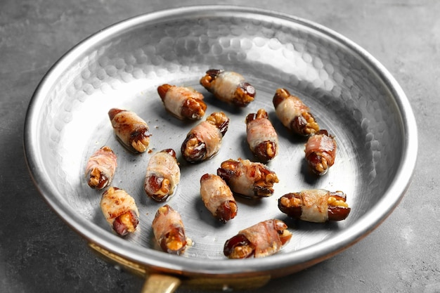 Bacon wrapped dates in frying pan