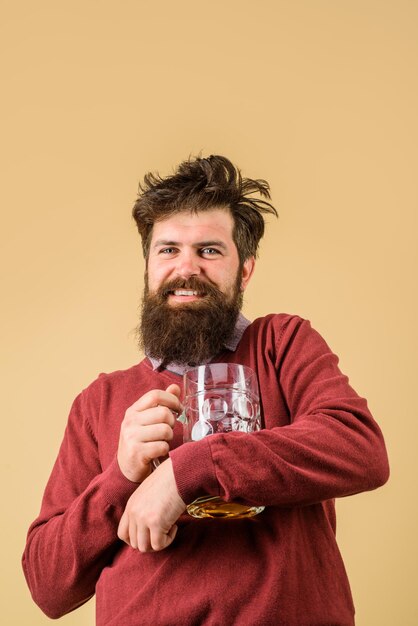 Bad habits drinks alcohol leisure and people concept bearded man drinking beer from glass at bar or