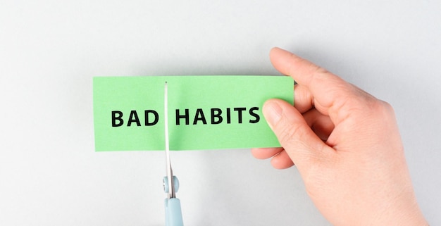 Photo bad habits sign cut with scissors break a habit stop smoking quit drinking alcohol and unhealthy