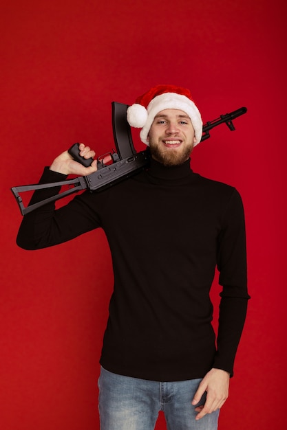 Bad Santa. A man in the image of Santa Claus with a machine gun