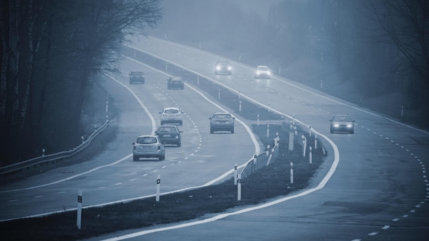 Bad weather driving  foggy hazy country road Motorway  road traffic Winter time