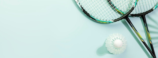 badminton banner with rackets and shuttlecock on blue background with copy space