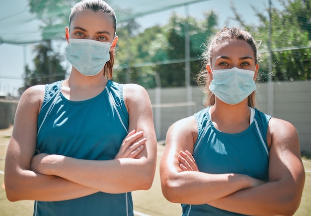 Badminton face mask and women with arms crossed for sports training and commitment as a team on court teamwork collaboration and portrait of friends with safety from covid during sport exercise