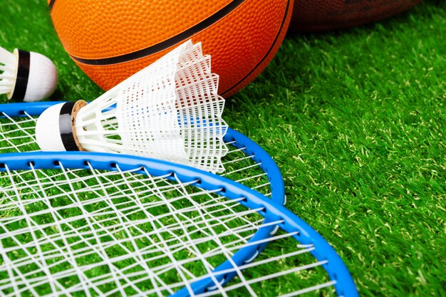 Badminton game rackets and shuttlecock on grass