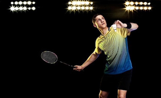 Badminton player in sportswear with racket and shuttlecock on stadium Individual sports Sports recreation