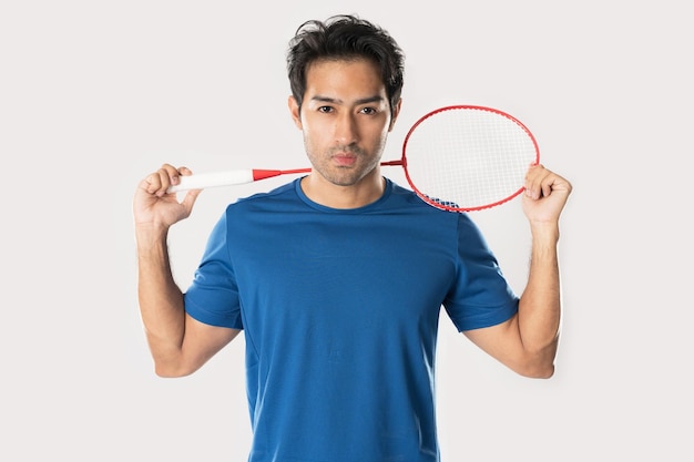 Badminton player wearing sportswear standing holding a racket