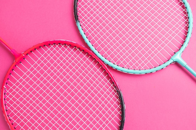 Badminton rackets on a bright pink.