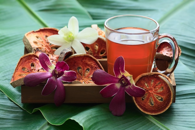 Photo bael fruit tea in wooden box.