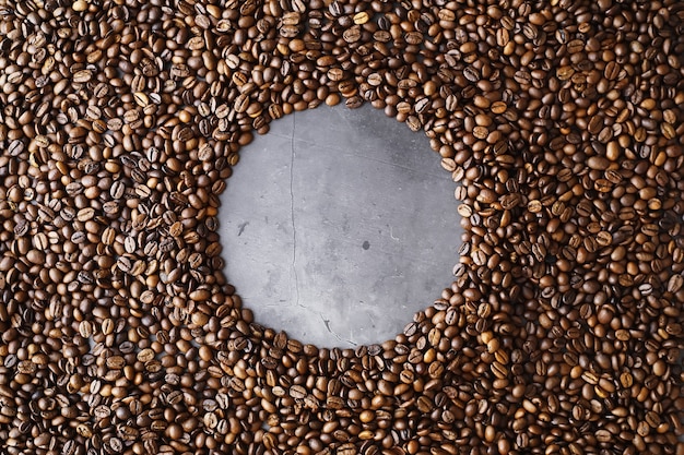 Bag of coffee. Coffee beans roasted on the table. Coffee beans with green leaves for cooking.