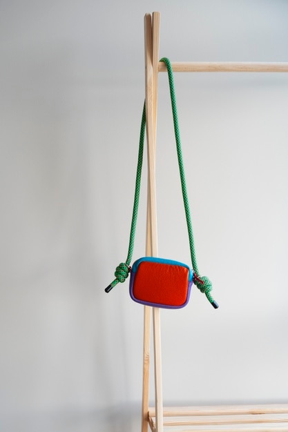 Photo bag hanging from furniture item indoors