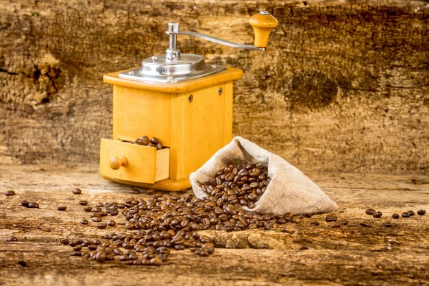 Bag with coffee beans Coffee grinder and bag with coffee beans in the background