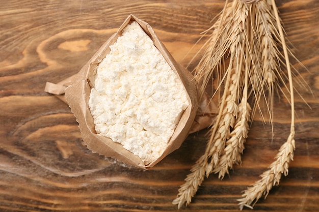 Bag with flour on wooden