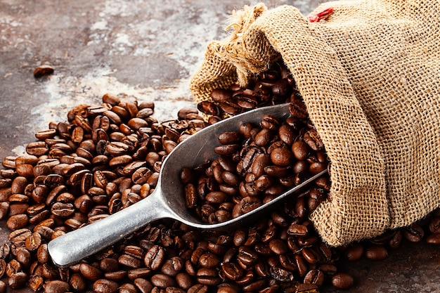 Bag with fresh roasted coffee lying on old rustic textured