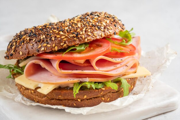 Bagel filled with ham cream cheese and tomato