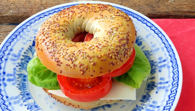 Bagel sandwich Fresh tomatoes Culinary delight Flavorful food Plate presentation Delicious