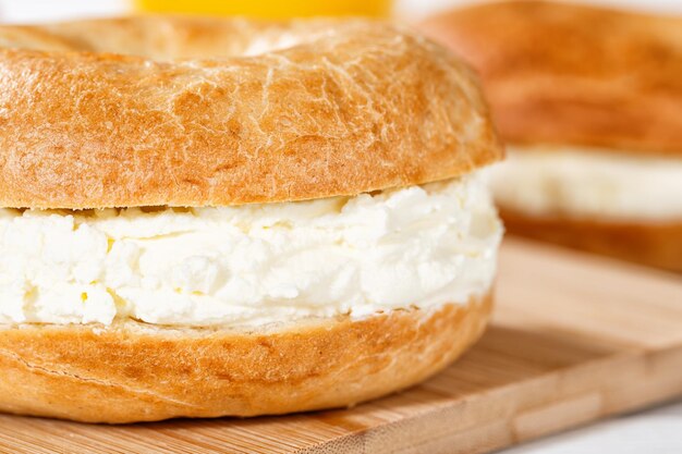 Bagel sandwich with cream cheese for breakfast close up