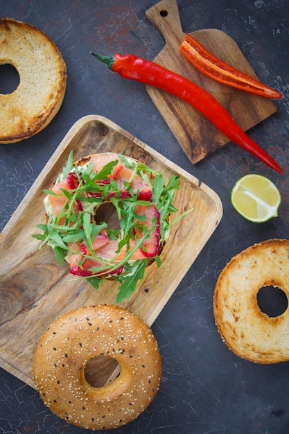 Bagel with salmon on a dark background, Breakfast bun