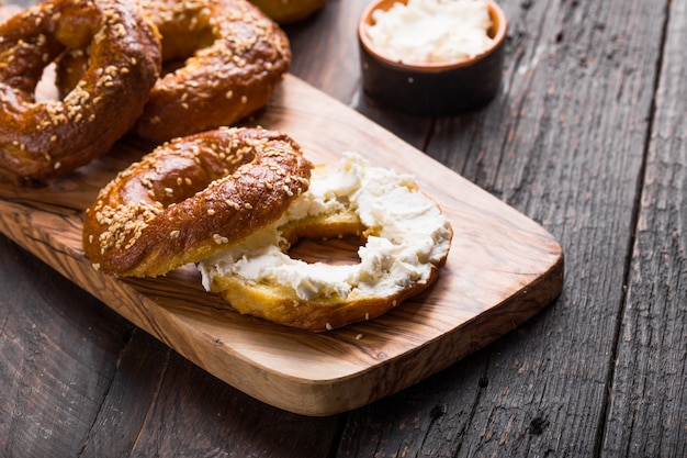 Bagels sandwich with cream cheese on wooden table