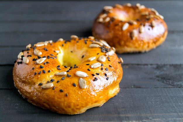 Bagels with seeds on a black background.