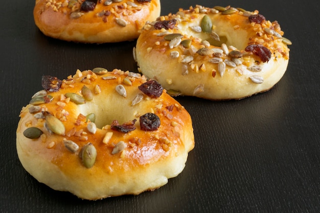 Bagels with seeds on a black background.