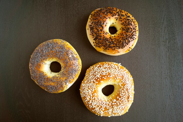 Bagels with sesame seeds on a black background