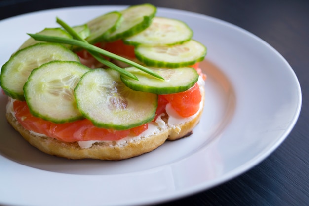 Bagels with sesame seeds on a black background