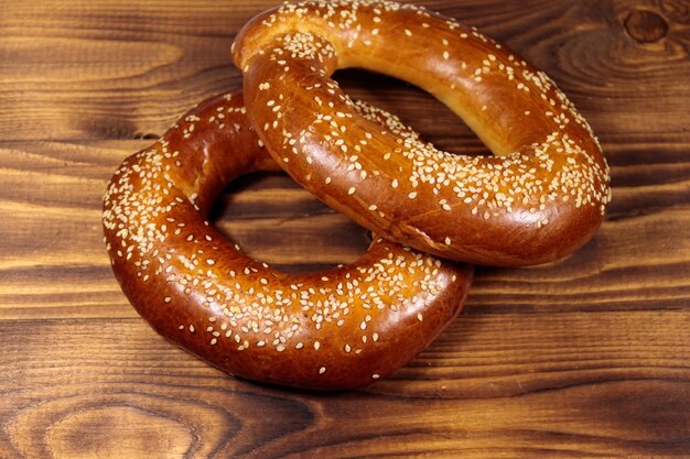 Bagels with sesame seeds on wooden table