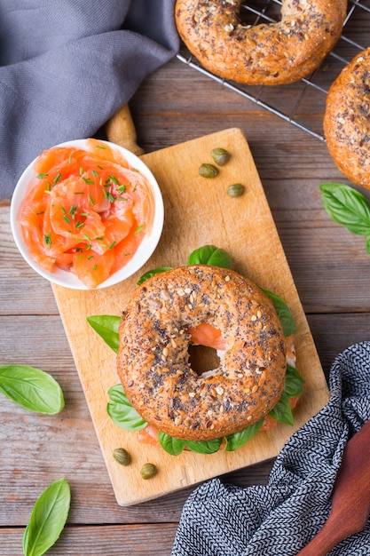 Bagels with smoked salmon, cream cheese and capers on a table. Food, lunch, brunch, meal on a plate, plating concept