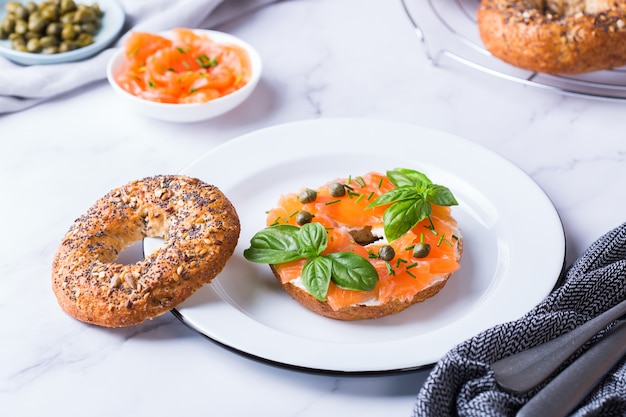 Bagels with smoked salmon, cream cheese and capers on a table. Lunch, meal idea