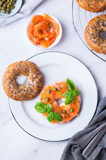 Bagels with smoked salmon, cream cheese and capers on a table