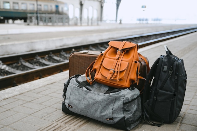 Bags at railway station near railroad travel concept