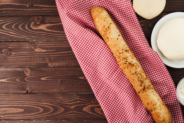 Baguette bread on brown wooden board