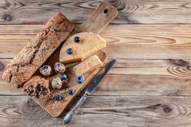 Baguette, cheese with spices and herbs, quail eggs, blueberries. 